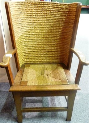 Lot 1253 - An Oak and Rush Orkney Chair, early 20th century, with outswept arms and drop-in seat, raised...