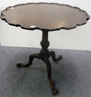 Lot 1254 - A George III Style Mahogany Carved Tripod Table, with scalloped edge and moulded top above a...