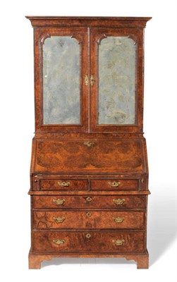 Lot 1265 - An Early Georgian Figured Walnut Bureau Bookcase, in three parts, circa 1720, the cavetto...