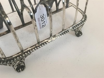 Lot 3012 - A George III Silver Toastrack, by Rebecca Emes and Edward Barnard, London, 1815, oblong and on four
