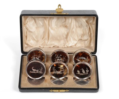 Lot 3054 - A Cased Set of Six George V Silver-Mounted Tortoiseshell Place-Card Holders, by William Comyns,...
