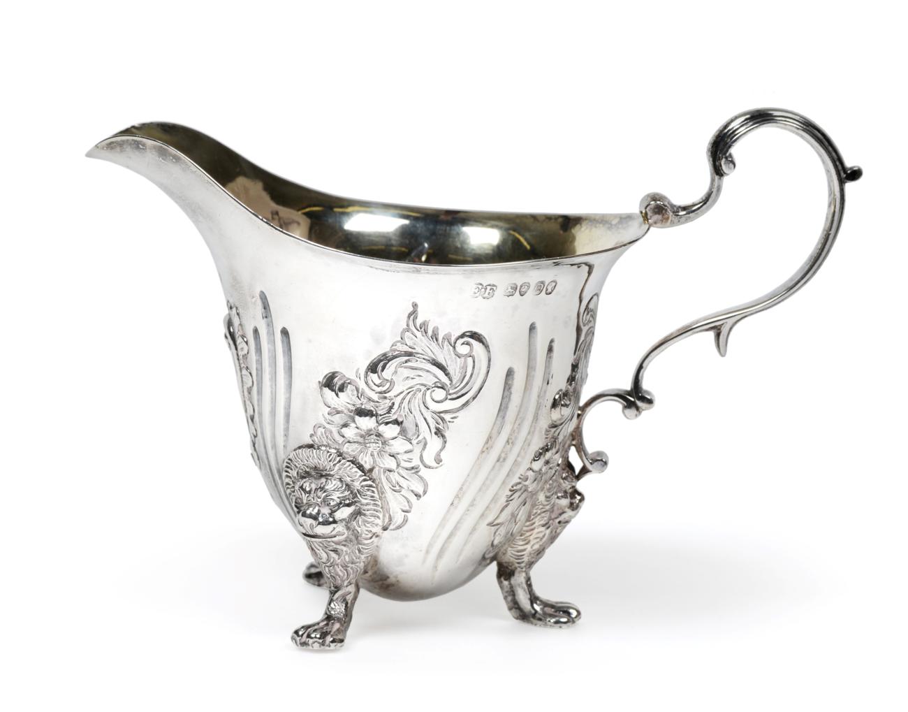Lot 3130 - A Victorian Silver Cream-Jug, by Edward Farrell, London, 1839, helmet shaped and on three lion-mask
