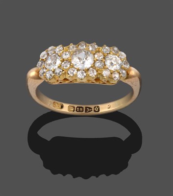 Lot 3229 - An 18 Carat Gold Diamond Triple Cluster Ring, three graduated old cut diamonds within borders...