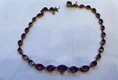 Lot 3238 - A 19th Century Amethyst Rivière Necklace, thirty graduated oval cut amethysts in yellow collet...