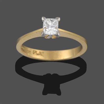 Lot 3242 - An 18 Carat Gold Diamond Solitaire Ring, the princess cut diamond in a white claw setting, to a...
