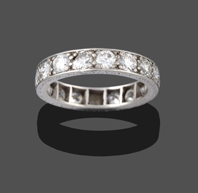 Lot 3251 - A Diamond Eternity Ring, the round brilliant cut diamonds in white claw settings, with engraved...