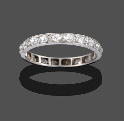 Lot 3253 - A Diamond Eternity Ring, the old cut diamonds in white claw settings, to a flat sided shank,...