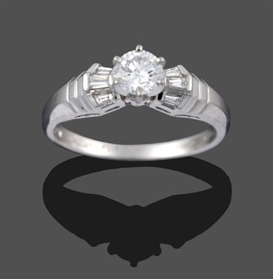 Lot 3254 - A Platinum Diamond Solitaire Ring, a round brilliant cut diamond in a claw setting, to tapered...