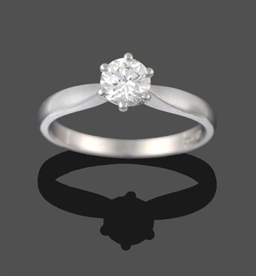 Lot 3256 - A Platinum Diamond Solitaire Ring, a round brilliant cut diamond in a claw setting, to knife...