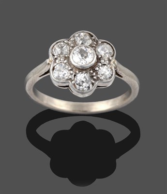 Lot 3259 - A Diamond Cluster Ring, seven old cut diamonds in white millegrain settings, to a tapered...