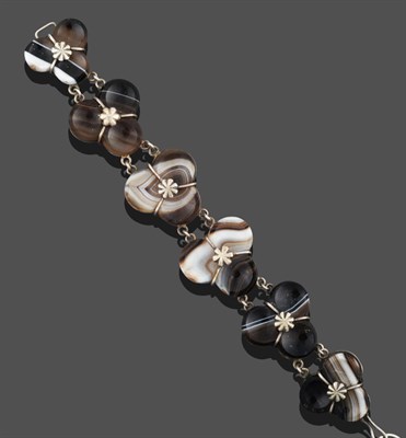Lot 3260 - A Sardonyx Bracelet, six sardonyx trefoil links within fancy white mounts and white chain links...