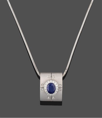 Lot 3263 - A Sapphire and Diamond Pendant on Chain, an oval cut sapphire within a border of round...