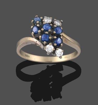 Lot 3271 - An Abstract 18 Carat White Gold Sapphire and Diamond Cluster Ring, twist shoulders terminating...