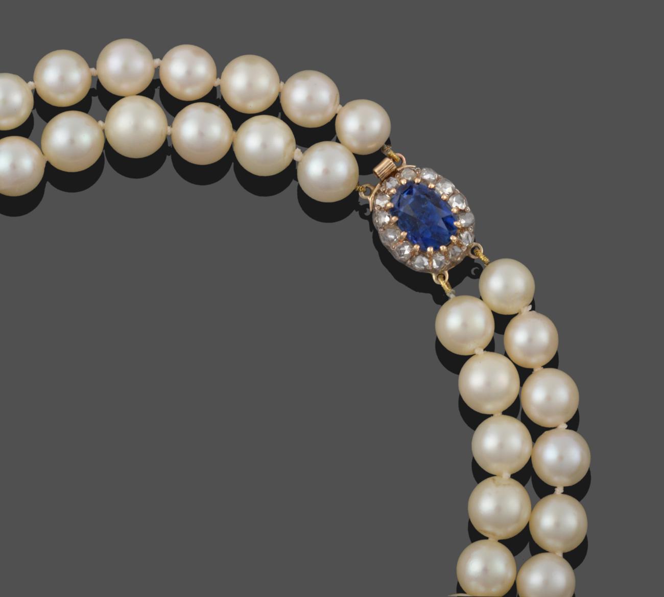 Lot 3272 - A Two Row Cultured Pearl Necklace, the 47:48 cultured pearls knotted to an oval clasp comprising of