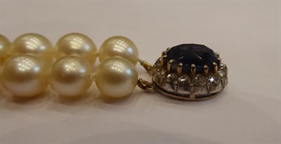 Lot 3272 - A Two Row Cultured Pearl Necklace, the 47:48 cultured pearls knotted to an oval clasp comprising of