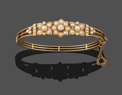 Lot 3278 - A Cultured Pearl and Diamond Bangle, three graduated cultured and split pearl set floral motifs the
