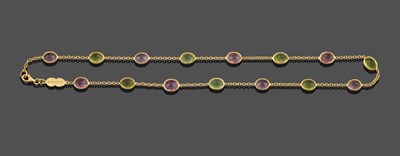 Lot 3296 - An 18 Carat Gold Peridot and Pink Tourmaline Necklace, eight oval cut pink tourmalines...