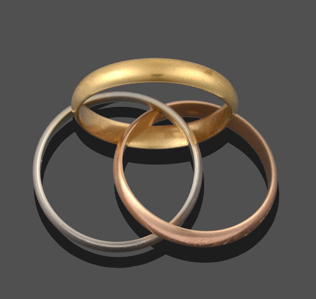 Lot 3297 - A Trinity Ring, by Cartier, three entwined yellow, rose and white bands, finger size L1/2 see...