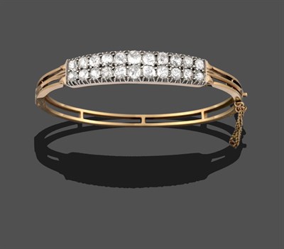 Lot 3298 - A Diamond Bangle, two rows of graduated old cut diamonds in white claw settings, to a yellow hinged