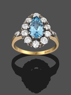Lot 3305 - An Aquamarine and Diamond Cluster Ring, the central pear cut aquamarine within a border of...