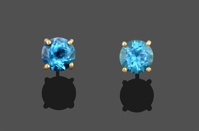 Lot 3308 - A Pair of Blue Topaz Earrings, the round cut blue topaz in a yellow four claw setting, with...