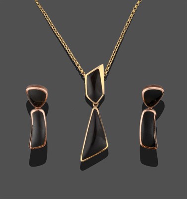 Lot 3310 - A 9 Carat Gold Jet Pendant on Chain, an irregular asymmetric shaped piece of jet suspends a...