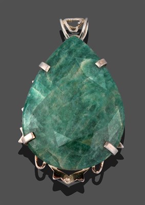 Lot 3317 - An Emerald Pendant, the pear cut emerald in a white claw setting to a scroll border, measures 7.9cm