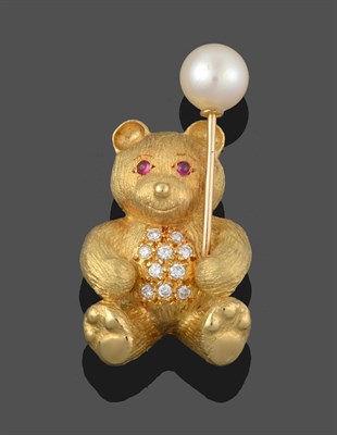 Lot 3341 - An 18 Carat Gold Diamond, Ruby and Cultured Pearl Teddy Bear Brooch, the yellow textured bear...