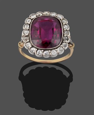 Lot 3342 - A Synthetic Ruby and Diamond Cluster Ring, a cushion cut synthetic ruby within a border of old...