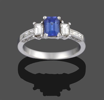 Lot 3347 - An Art Deco Style Tanzanite and Diamond Three Stone Ring, the central emerald-cut tanzanite...