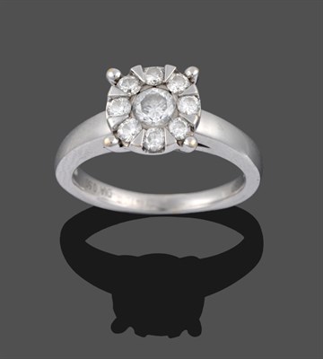 Lot 3362 - An 18 Carat White Gold Diamond Cluster Ring, a round brilliant cut diamond within a border of...