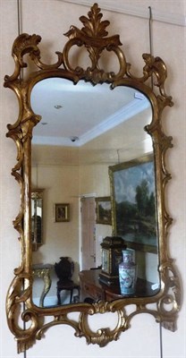 Lot 1316 - A George II Style Gilt and Gesso Wall Mirror, with shaped rectangular plate, within a C scroll...