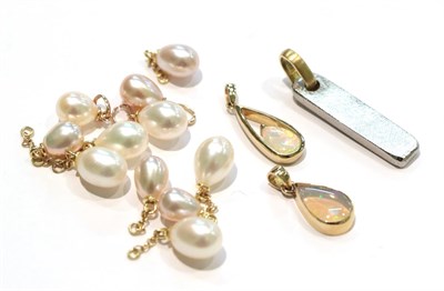 Lot 219 - Eleven cultured pearl charms/pendants, unmarked; together with a 9 carat gold opal pendant,...