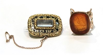 Lot 227 - A cornelian intaglio seal ring, unmarked, finger size L; and a mourning brooch, length 3.2cm