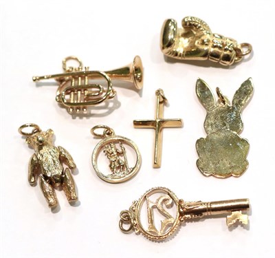 Lot 242 - Five 9 carat gold charms/pendants comprising of a boxing glove, a cross, a trumpet, a rabbit...