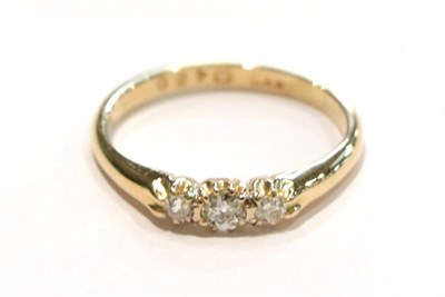 Lot 245 - A diamond three stone ring, the graduated round brilliant cut diamonds in yellow claw settings,...