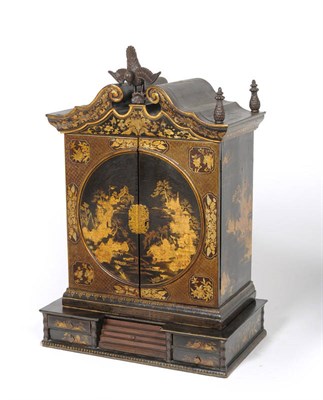 Lot 1323 - A Chinese Export Black and Gilt Export Lacquered Cabinet, circa 1800, the scrolling broken neck...