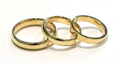 Lot 250 - Three 18 carat gold band rings, finger sizes K, M and T