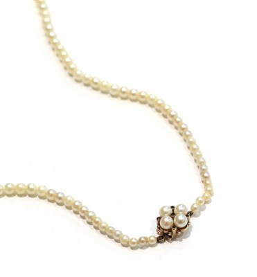 Lot 258 - A graduated cultured pearl necklace with a 9 carat gold garnet and cultured pearl cluster snap,...