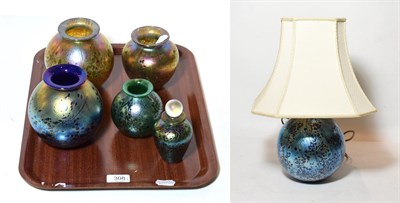 Lot 308 - Four Isle of Wight iridescent glass vases; a scent bottle and stopper; a similar table lamp and...