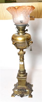 Lot 311 - An impressive Victorian brass oil lamp with etched shade with three spare chimneys, 67cm...