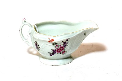 Lot 328 - A Worcester porcelain sauce boat, circa 1770, painted with flower sprays and scattered sprigs...