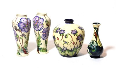 Lot 334 - A pair of modern Moorcroft pottery vases each decorated with stylised flowers on cream grounds...