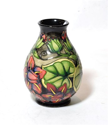 Lot 337 - A modern Moorcoft pottery vase decorated with stylised flowers and leaves, with painted and...