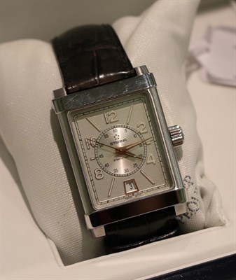 Lot 351 - A rectangular stainless steel automatic calendar centre seconds wristwatch, signed Eterna...