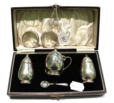 Lot 367 - An Art Deco silver three-piece cruet set, of stylised form, W.G & S, Birmingham, 1936; together...