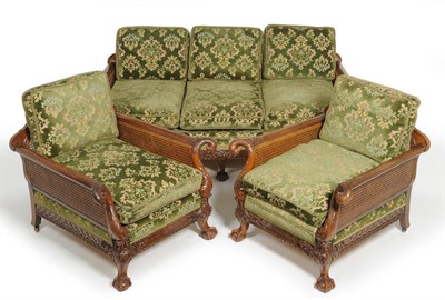 Lot 1339 - An Early 20th Century Carved Mahogany and Double Caned Three Seater Bergere Settee, with six...