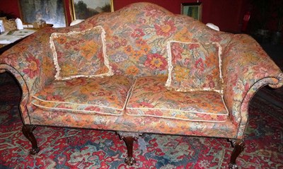 Lot 1341 - A Pair of Settees in the George II Style, upholstered in floral damask, the undulating back between