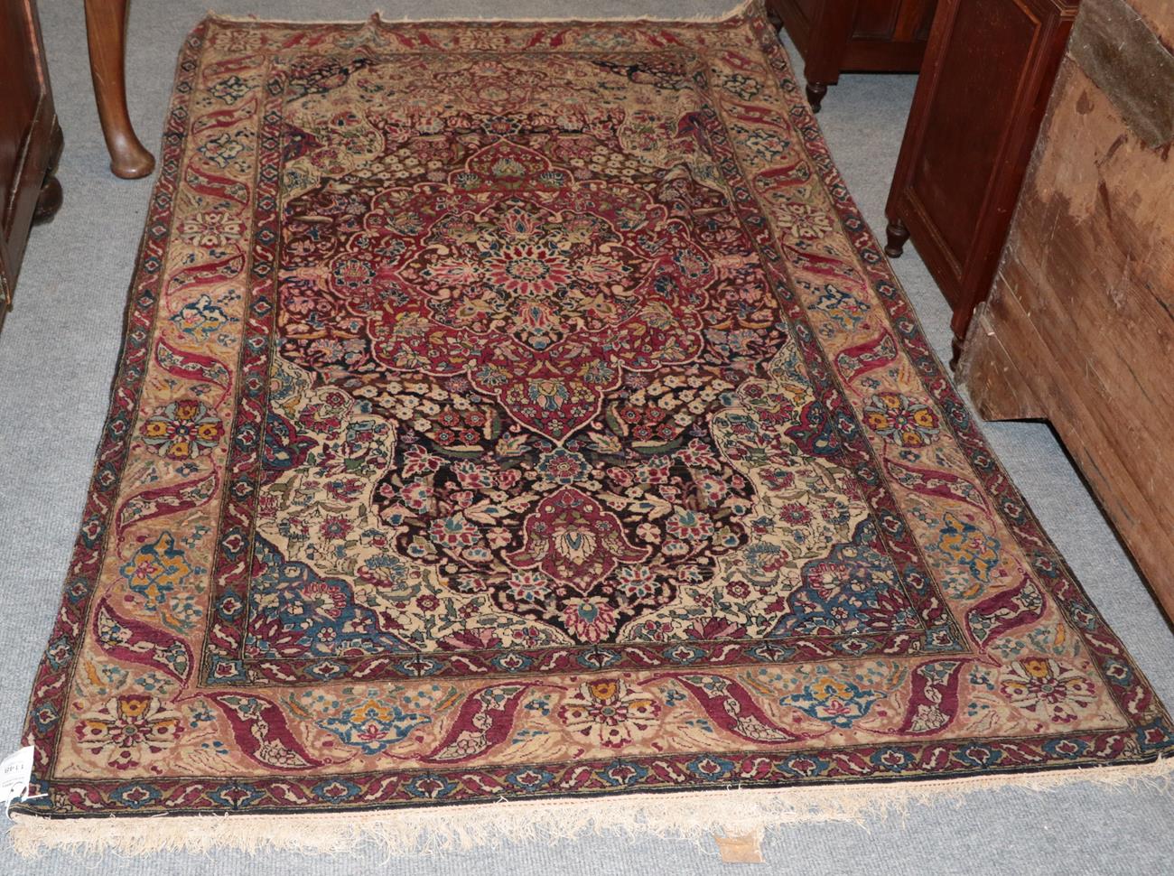 Lot 1148 - Isfahan rug, Central Iran, circa 1925, The abrashed walnut brown field centred by a cusped...