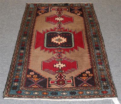 Lot 1153 - A Hamadan rug, the camel field with three serrated medallions enclosed by sky blue borders,...